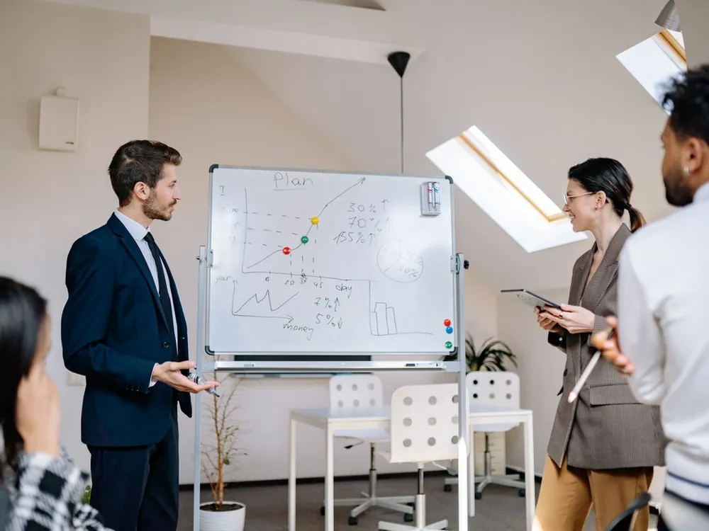 Team planning at a whiteboard in a bright office