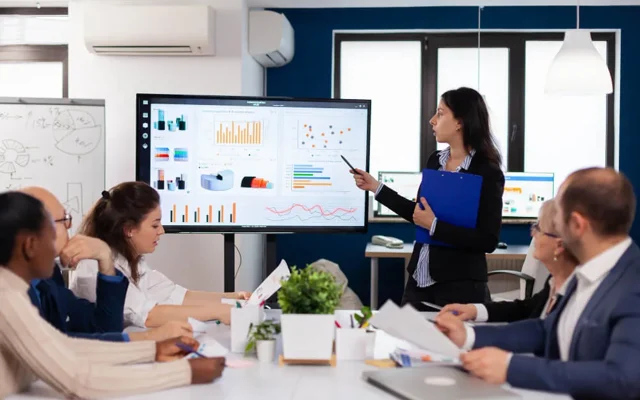 A team attending a presentation in a meeting room